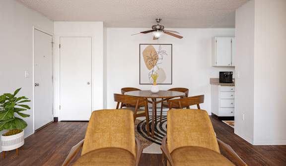 A dining room with a wooden table and chairs.
