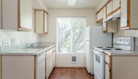 a kitchen with white appliances and wooden cabinets
