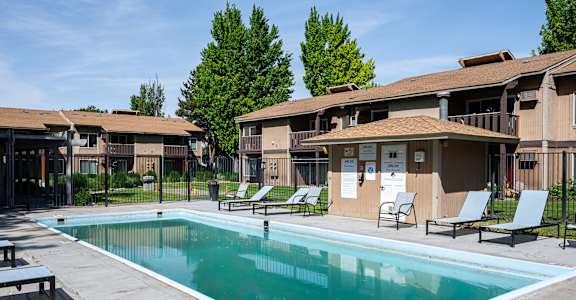 A swimming pool in front of apartment buildings.