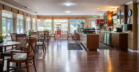 A restaurant with wooden floors and furniture.