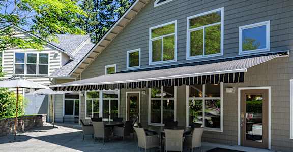 A house with a patio and a table set for six.