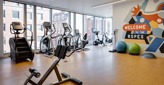 A gym with a sign that says "Welcome to the Ropes".