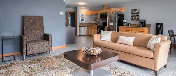 a living room with a couch a table and a chair