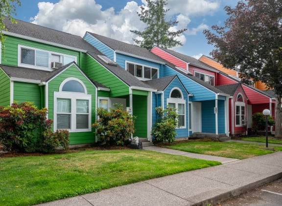 a row of colorful houses in a suburban neighborhood