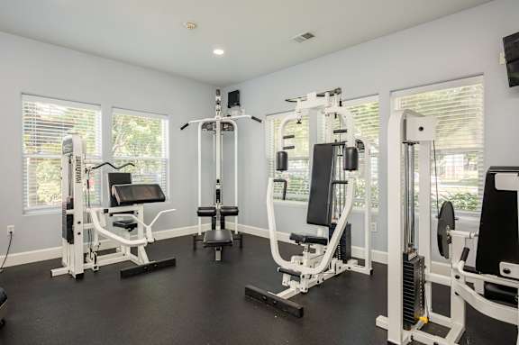 A well-equipped home gym with various exercise machines.
