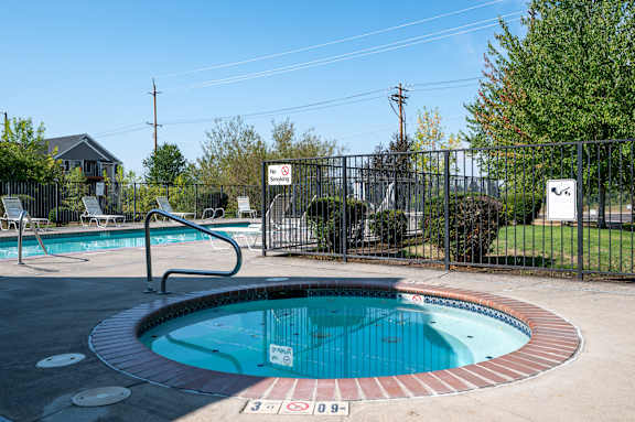 A pool with a sign that says "No Diving" is surrounded by a fence.