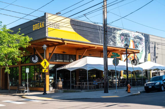 the front of a restaurant with a yellow and black building
