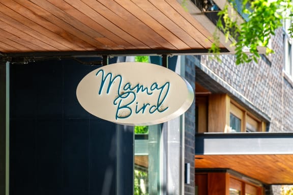 a sign that reads mango bird on the front of a building