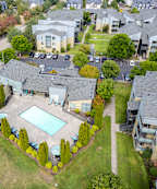 A sign for Briar Creek Apartments is surrounded by flowers.