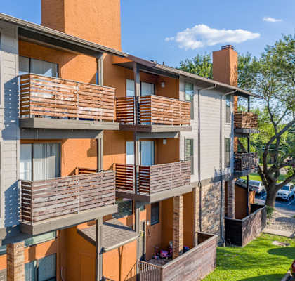 Apartment building with balconies and a sign that reads "2001-2004 704".