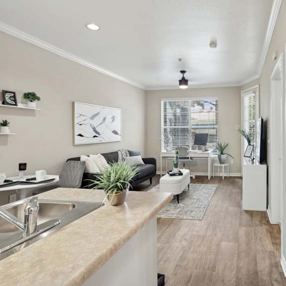 a living room with a fireplace and leather chairs