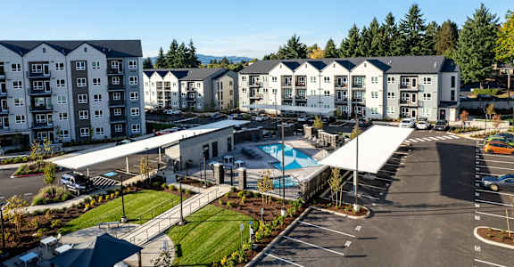an aerial view of an apartment building and a swimming pool