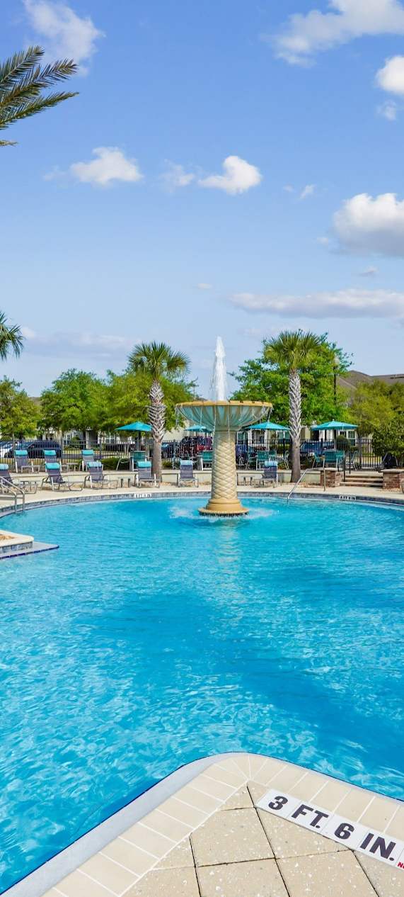 Dog park with a shaded bench for pet owners at Oakleaf Plantation in Jacksonville, FL