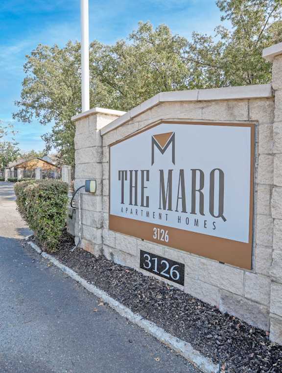 The Marq Apartment Homes sign is on a stone wall at The Marq apartments in Shreveport, LA