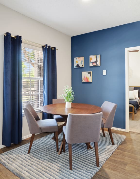 a dining room with a table and chairs