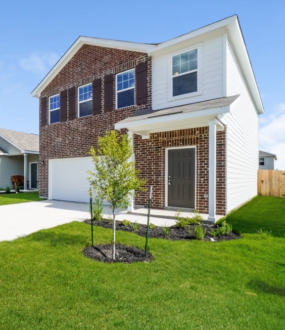 a house with a lawn in front of it at Beacon at Meridian, San Antonio, 78245