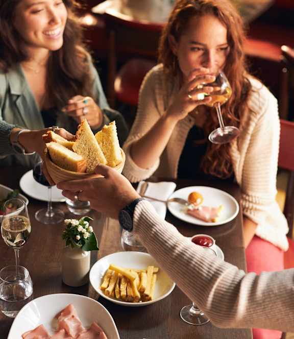 A group of people are enjoying a meal together at a restaurant.