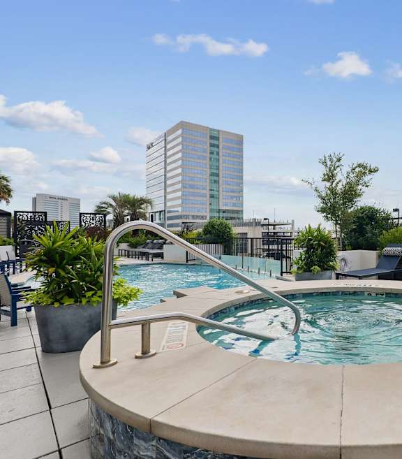 indoor lounge with a big white couch and white tile floors at Dominion Post Oak in Houston, TX