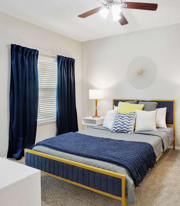a bedroom with a bed and a ceiling fan