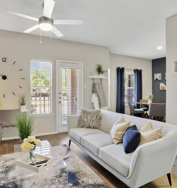 a living room with a blue accent wall and a white couch