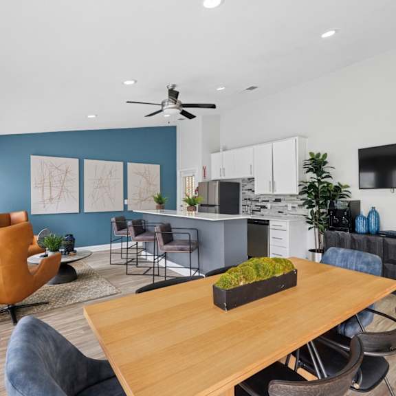 A modern kitchen with a dining table and chairs.