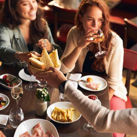 A group of people are enjoying a meal together at a restaurant.