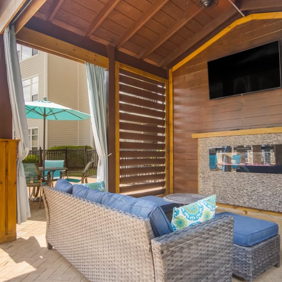 Comfortable sitting area by the pool with a relaxing couch at Angel Landing apartments in Pensacola, FL