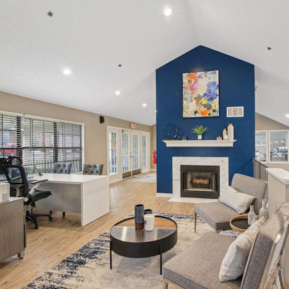 Leasing Office with lounge seating at fireplace at Woodmere Trace at Duluth, GA