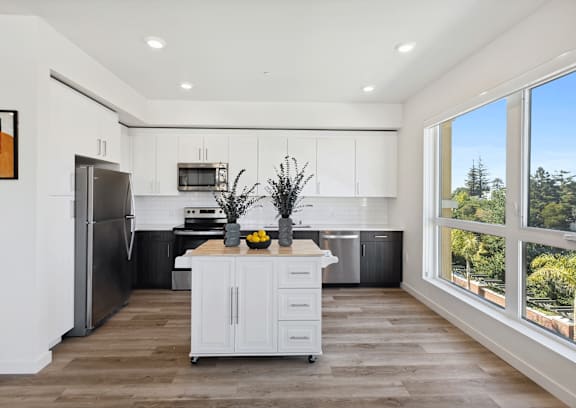 A modern kitchen with white cabinets and a large island.