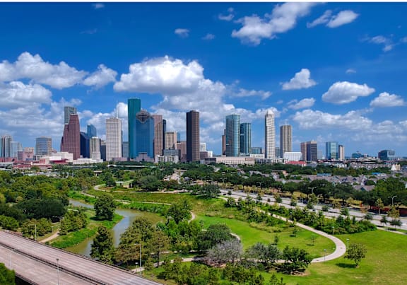 A city skyline with tall buildings and a river running through the city.