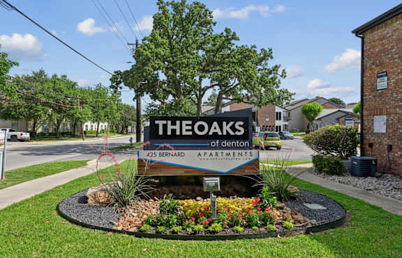 The entrance sign to The Oaks of Denton Apartments in Denton, TX