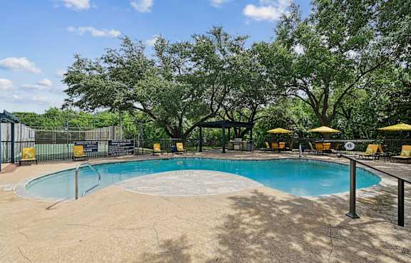 a backyard with a barbecue grill and a table and chairs