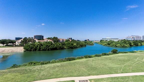 a gym with weights and cardio machines at Jefferson Creek in Irving, TX