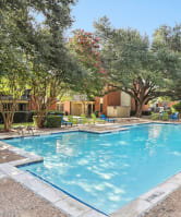 Swimming Pool, Shaded by Trees, at Hunters Chase Apartments in Austin, Texas, TX