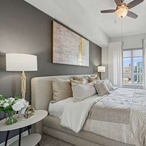 a bedroom with a large bed and a ceiling fan at Dominion Post Oak in Houston, TX