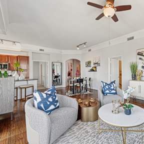 a living room with a red couch and a large window at Dominion Post Oak in Houston, TX