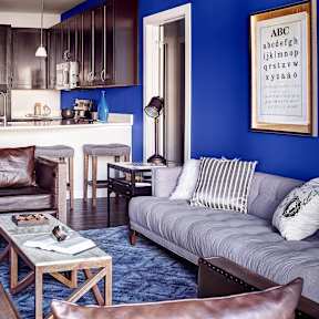 A living room with a grey couch and a coffee table.