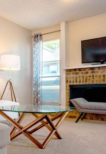 a white bedroom with a bed and a ceiling fan