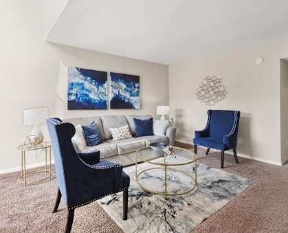 a living room with a couch and two chairs