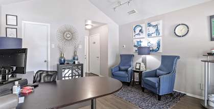 a living room with a table and chairs