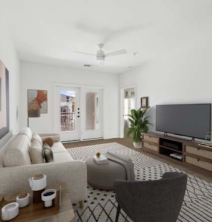 A living room with a couch, chair, and television.