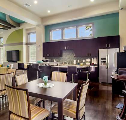 Clubhouse Kitchen area with tables and chairs and coffee maker at Oakleaf Plantation Apartments in Jacksonville, FL