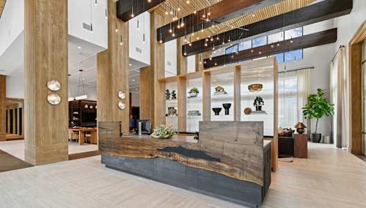 A reception area with a wooden bench and a display of shoes.