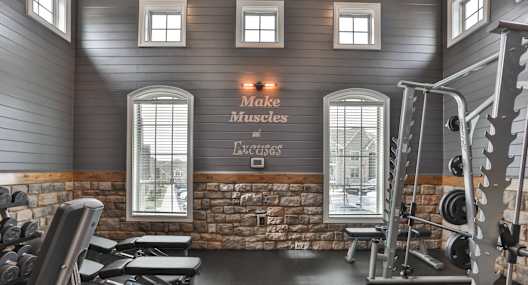 A gym with a sign that says "Make Muscles Excels".