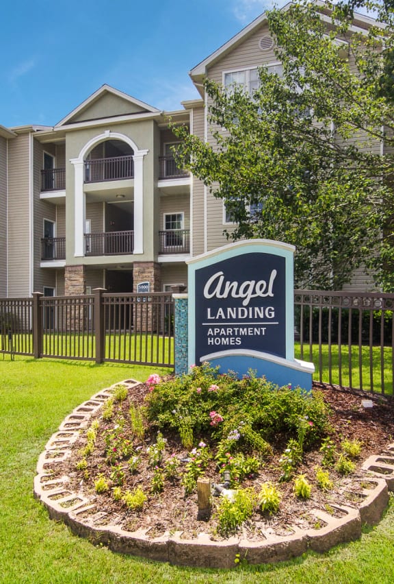 Monument entrance sign welcoming residents and visitors at Angel Landing apartments in Pensacola, FL