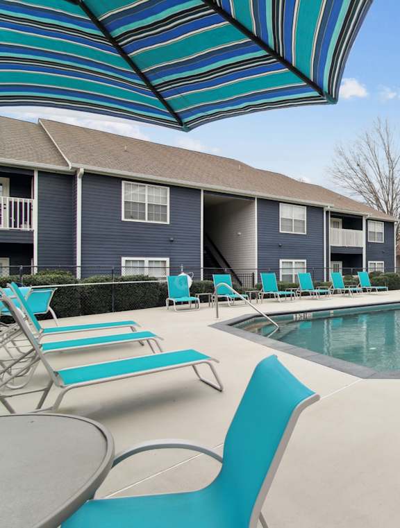 a gazebo with a table and chairs next to a pool at Columbus Apartments in Columbus, Georgia, GA