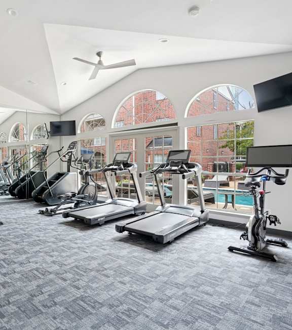 A spacious gym with treadmills, elliptical machines, and other exercise equipment.