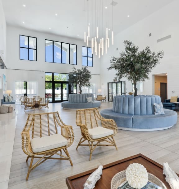 a lounge with a couch a coffee table and a kitchen in the background at Westgate on University in Lauderhill, FL
