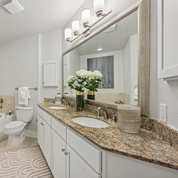 a bathroom with a bathtub and a toilet at Dominion Post Oak in Houston, TX