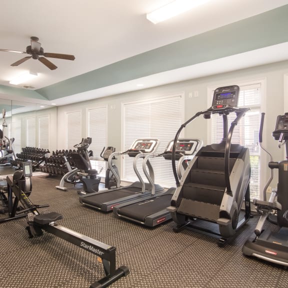 Fully equipped gym with modern workout machines at Angel Landing apartments in Pensacola, FL